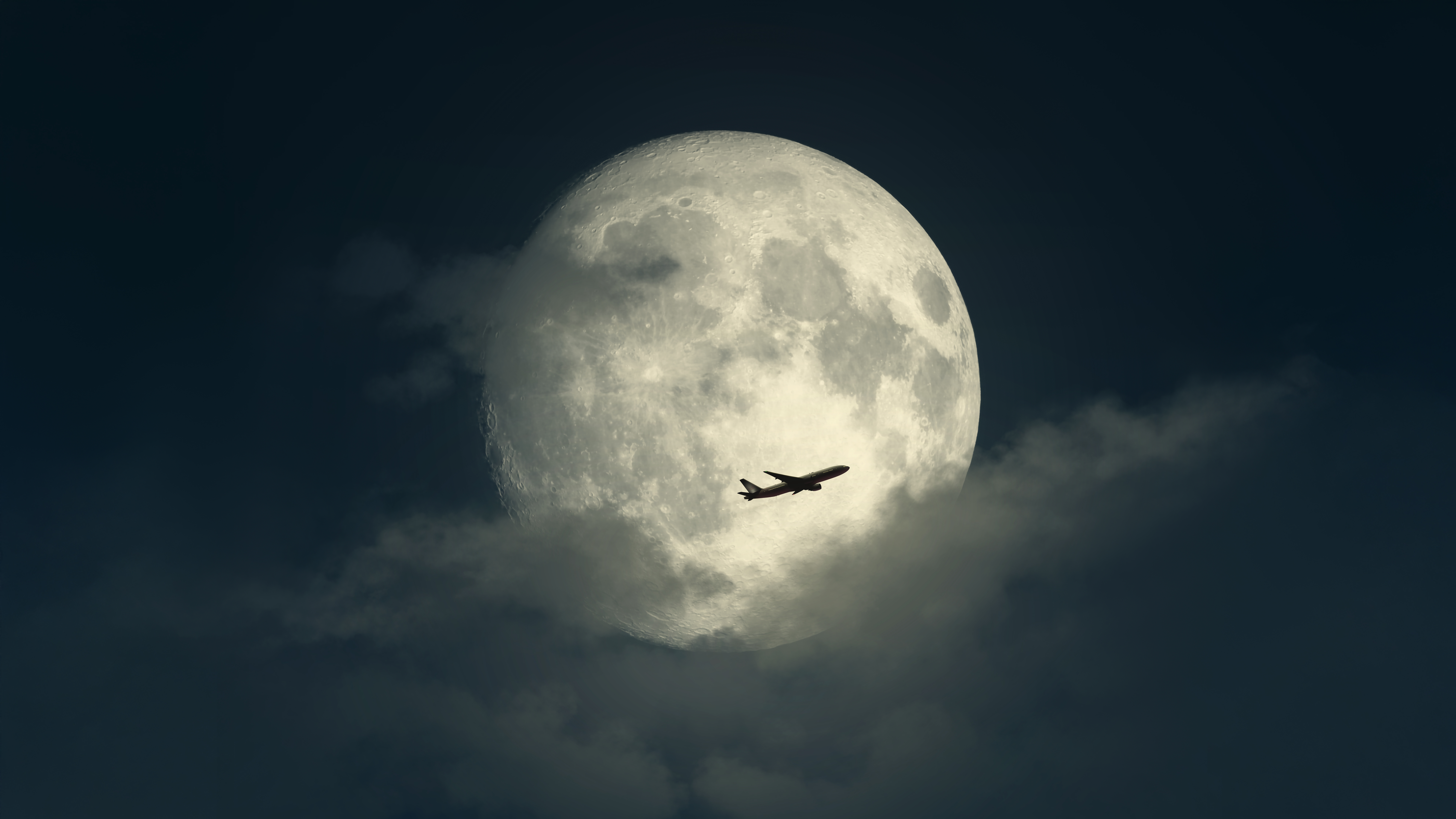 Airplane Silhouette Against Full Moon
